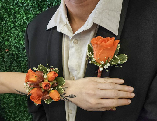 WC122 Orange Spray Rose Wrist Corsage and Boutonniere from Fabbrini's Flowers in Hoffman Estates, IL